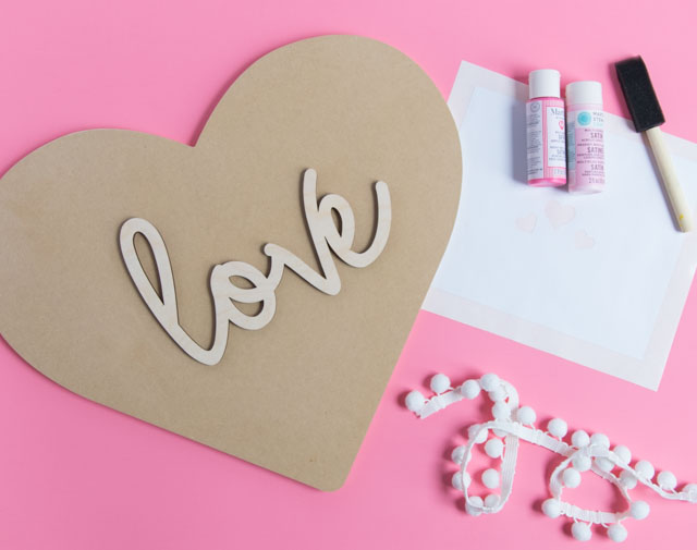 Make this pretty wood heart love decor for Valentine's Day! #woodheart #heartdecor #valentinescrafts #valentinesdecor #craftcuts #lovesign