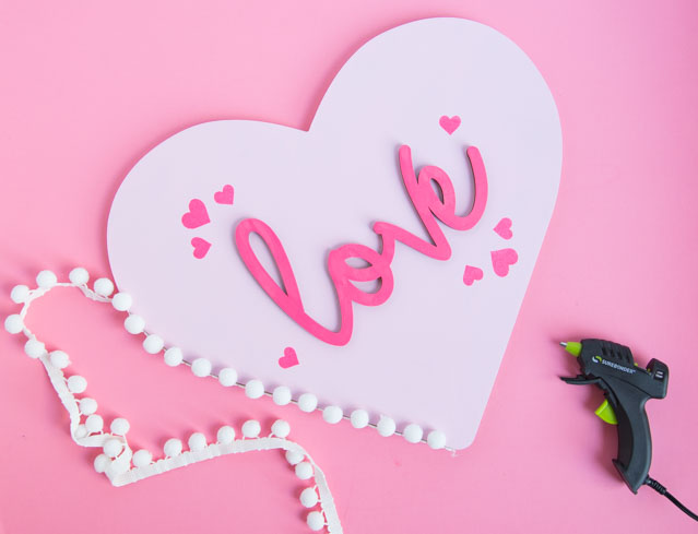 Make this pretty wood heart love decor for Valentine's Day! #woodheart #heartdecor #valentinescrafts #valentinesdecor #craftcuts #lovesign