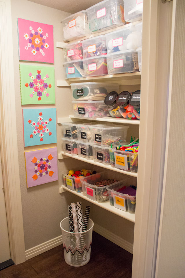 Craft closet organized with clear storage bins