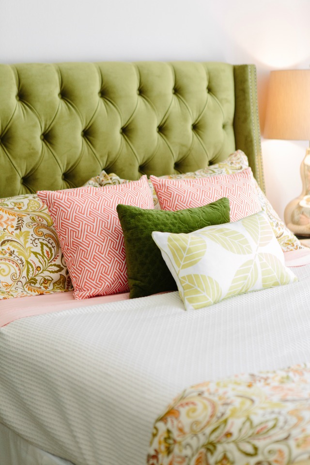 Bed with green tufted headboard