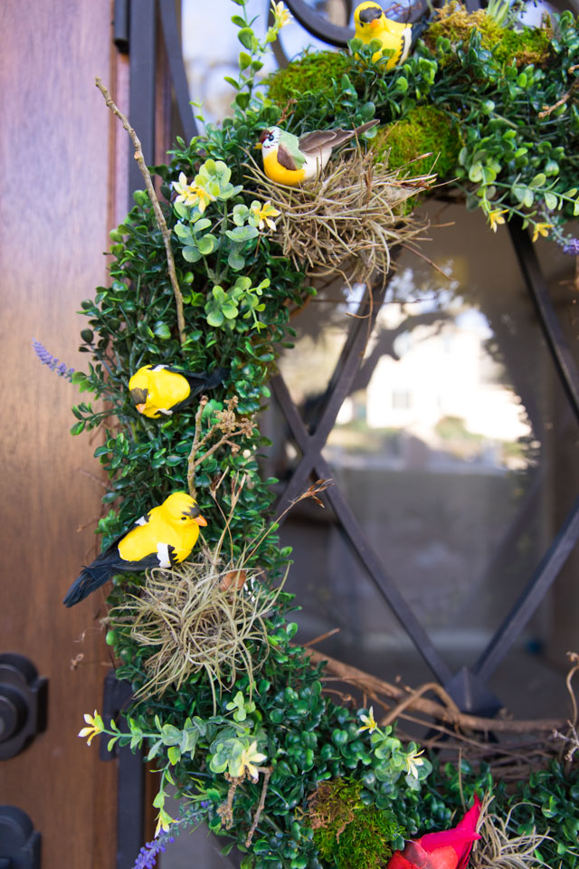 Make a beautiful spring wreath with faux birds, greenery, and nature elements. #birdwreath #springwreath #naturecrafts #birdcrafts