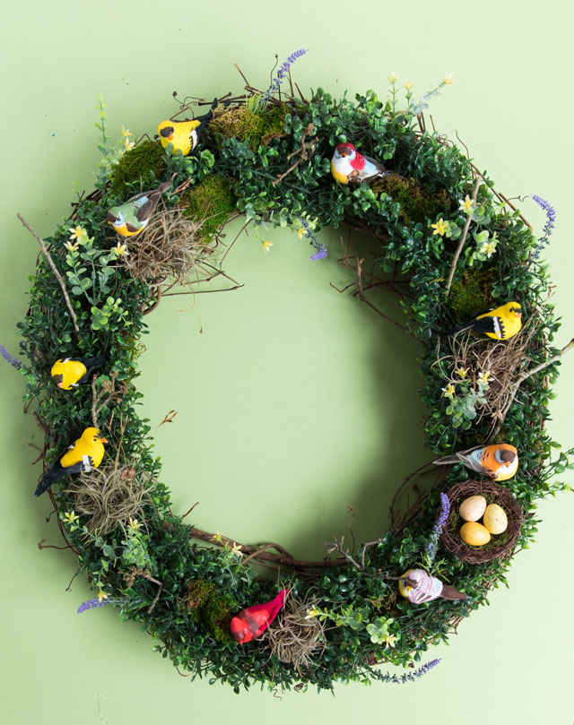 Make a beautiful spring wreath with faux birds, greenery, and nature elements. #birdwreath #springwreath #naturecrafts #birdcrafts