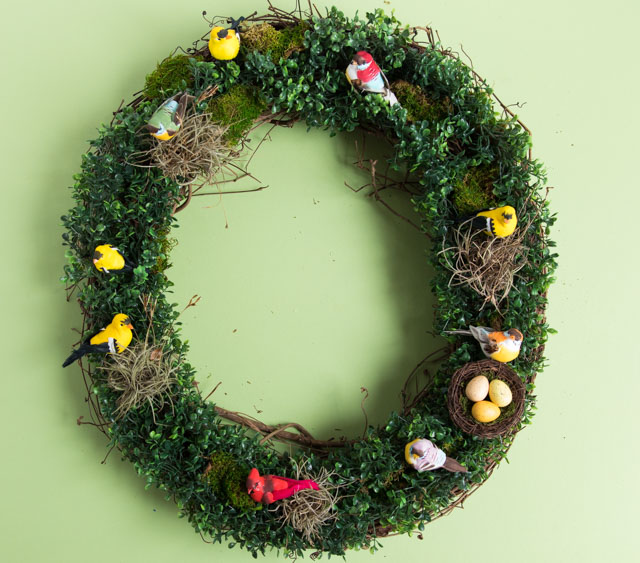 Make a beautiful spring wreath with faux birds, greenery, and nature elements. #birdwreath #springwreath #naturecrafts #birdcrafts