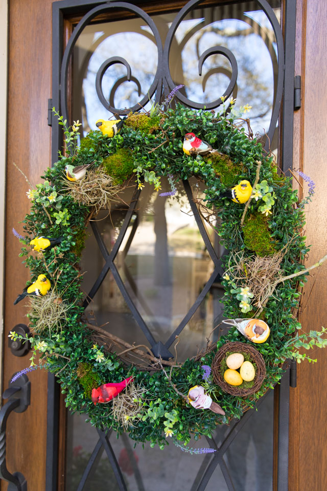 Make a beautiful spring wreath with faux birds, greenery, and nature elements. #birdwreath #springwreath #naturecrafts #birdcrafts