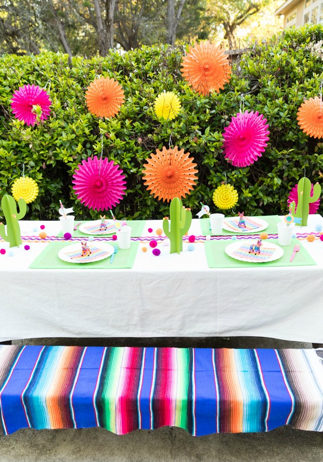 Backyard fiesta party table with paper fans