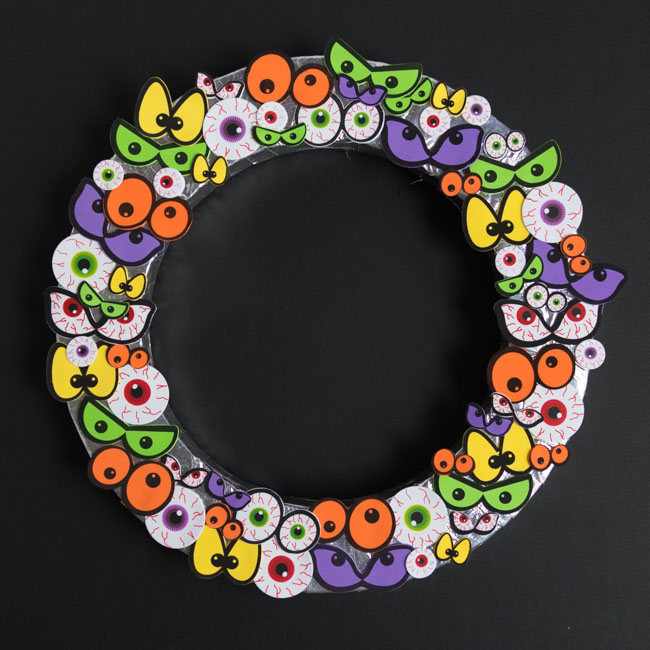 Wreath form covered with eyeballs