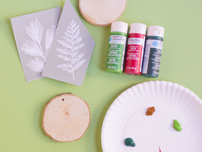 Supplies for DIY stenciled wood sliced ornaments