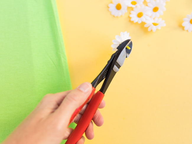 Clipping stems from artificial flowers with wire cutters