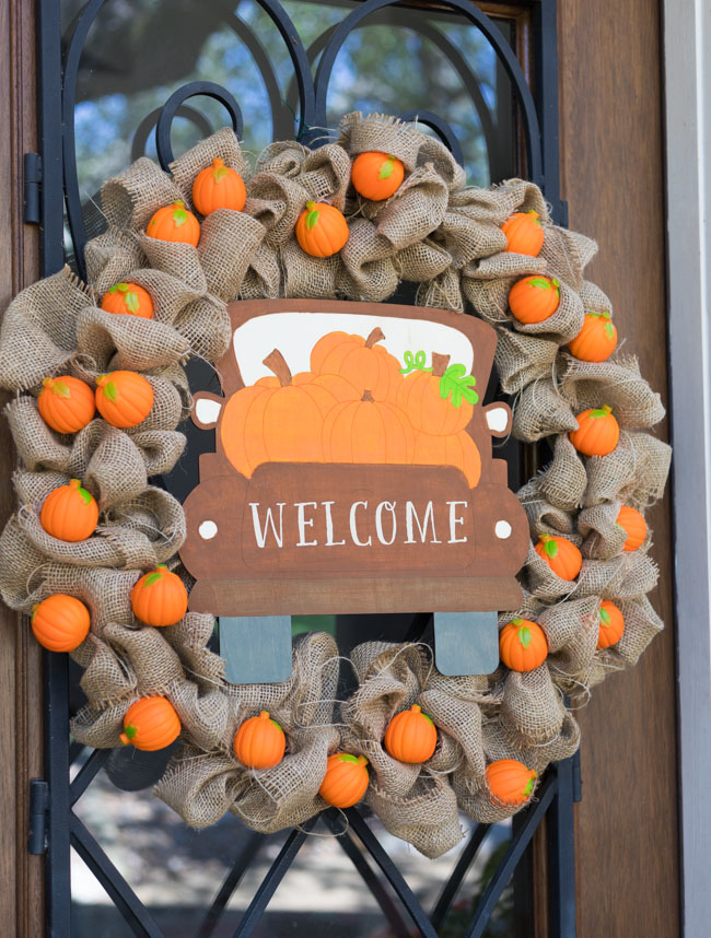 Beautiful DIY Thanksgiving wreaths adorned with autumn leaves, pumpkins, and berries.