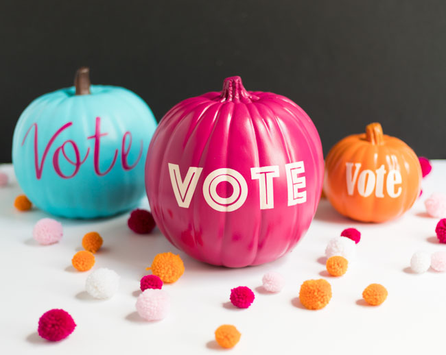 This is an image of pumpkins decorated with the word vote