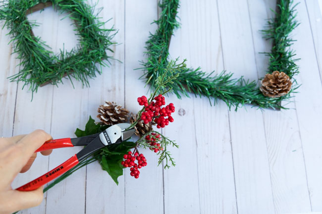 Clipping pinecones from stems with wire cutters