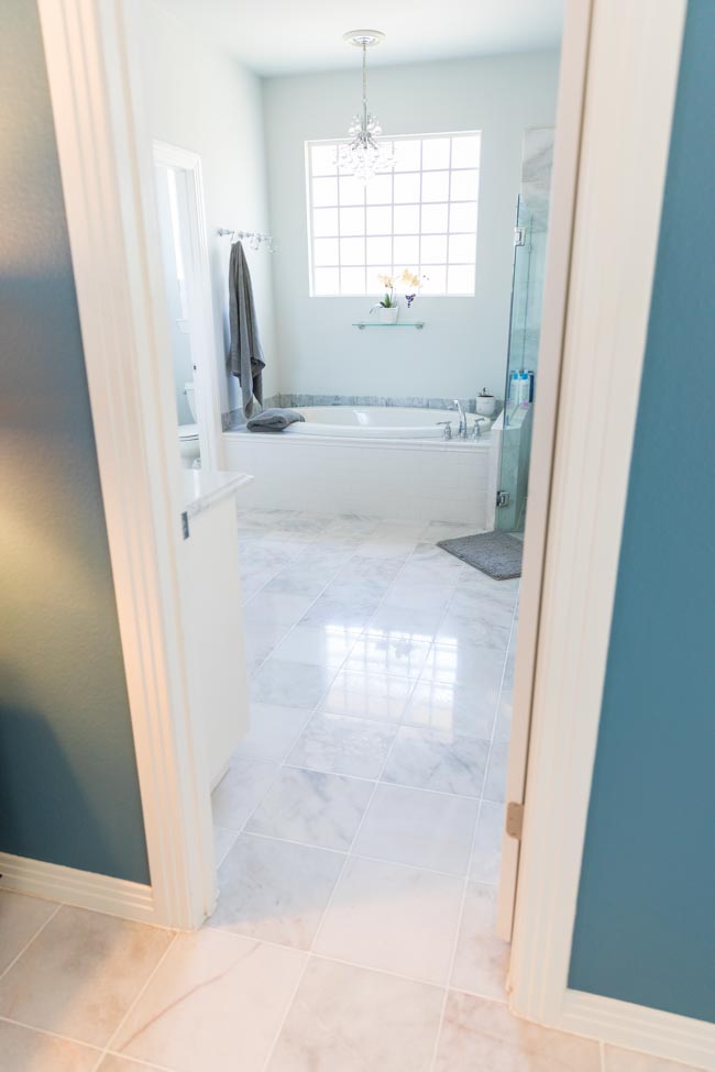 Bathroom with polished carrara marble floors